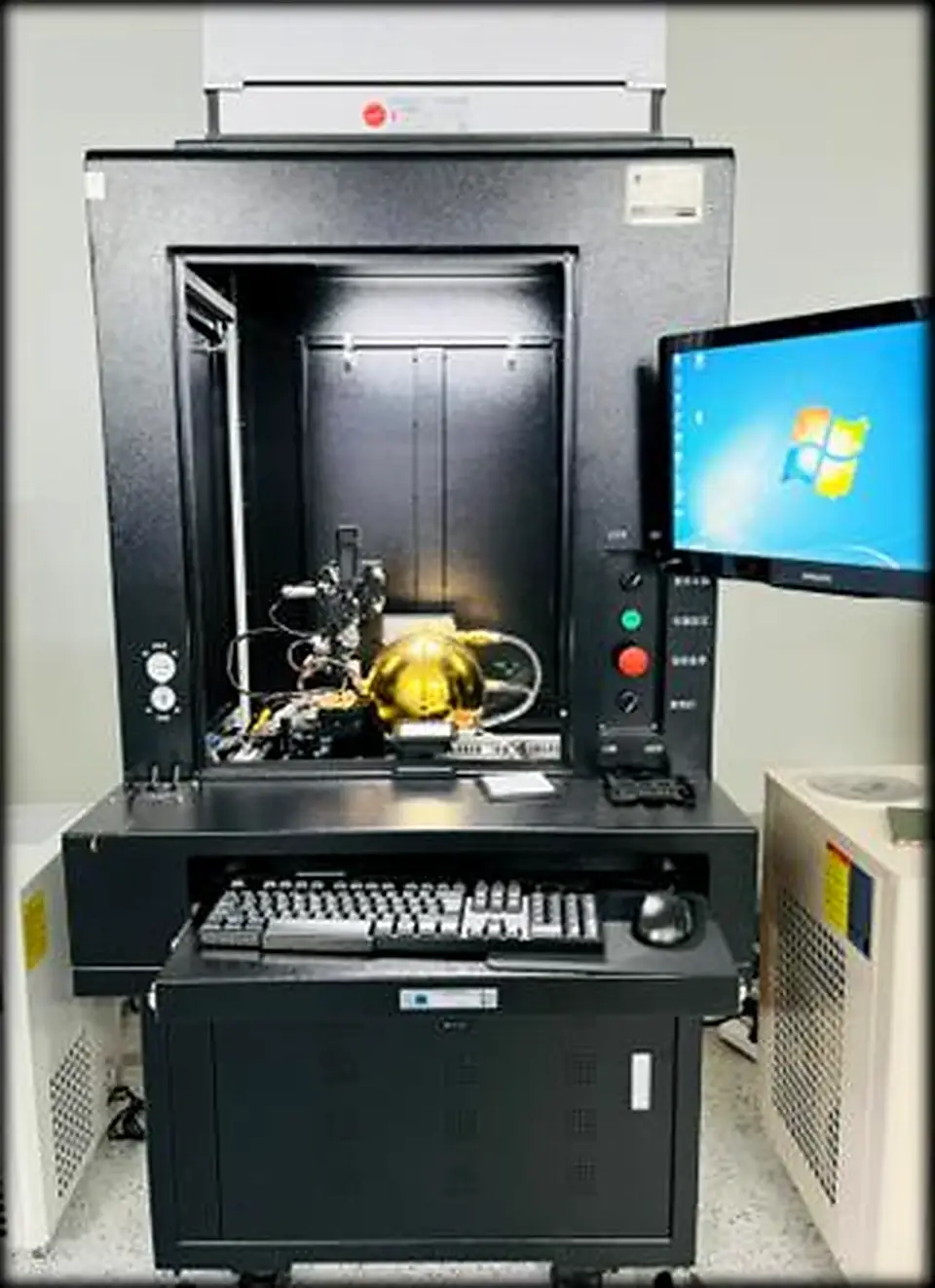 Enclosed bare-bar laser test system with optical fixture, cooling equipment and computer control