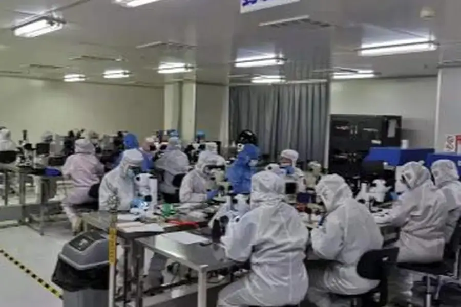 Lumexis personnel working in a controlled cleanroom production area.