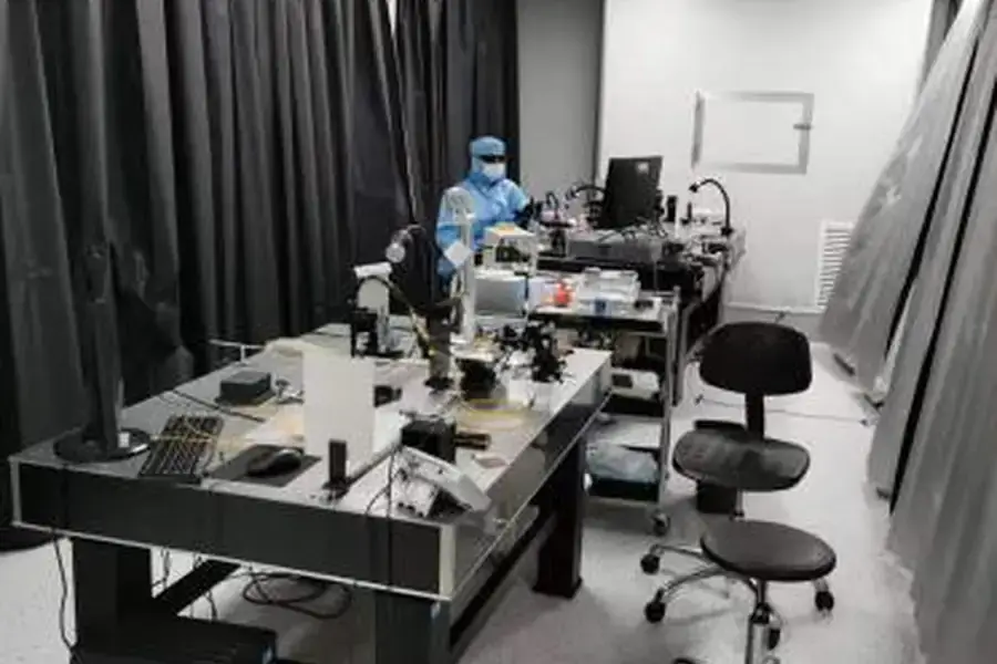 Technician working at a controlled Lumexis precision assembly station.
