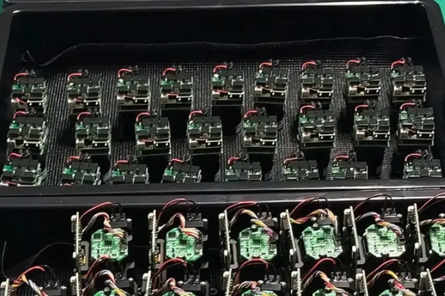 Trays of laser rangefinder module assemblies prepared for controlled production verification
