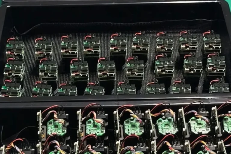 Trays of laser rangefinder module assemblies prepared for controlled pre-production evaluation.