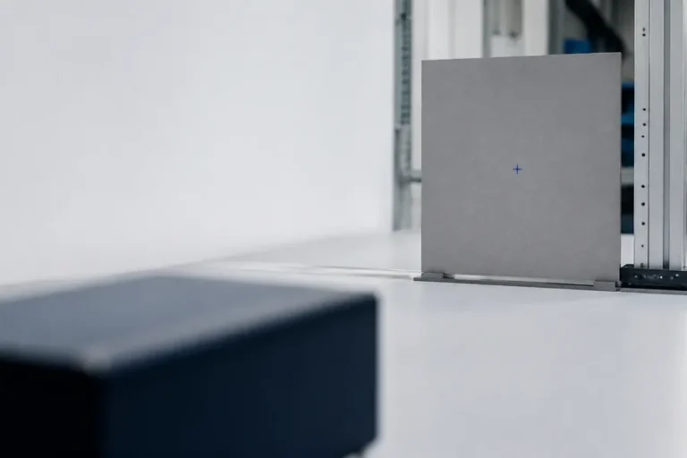 Conceptual industrial measurement scene with a neutral target panel positioned along a controlled optical work area.